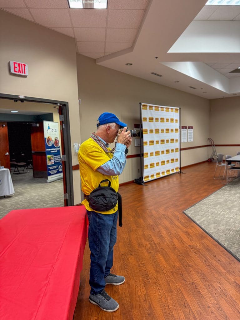 man taking photos at Heartland Caregiving Conference