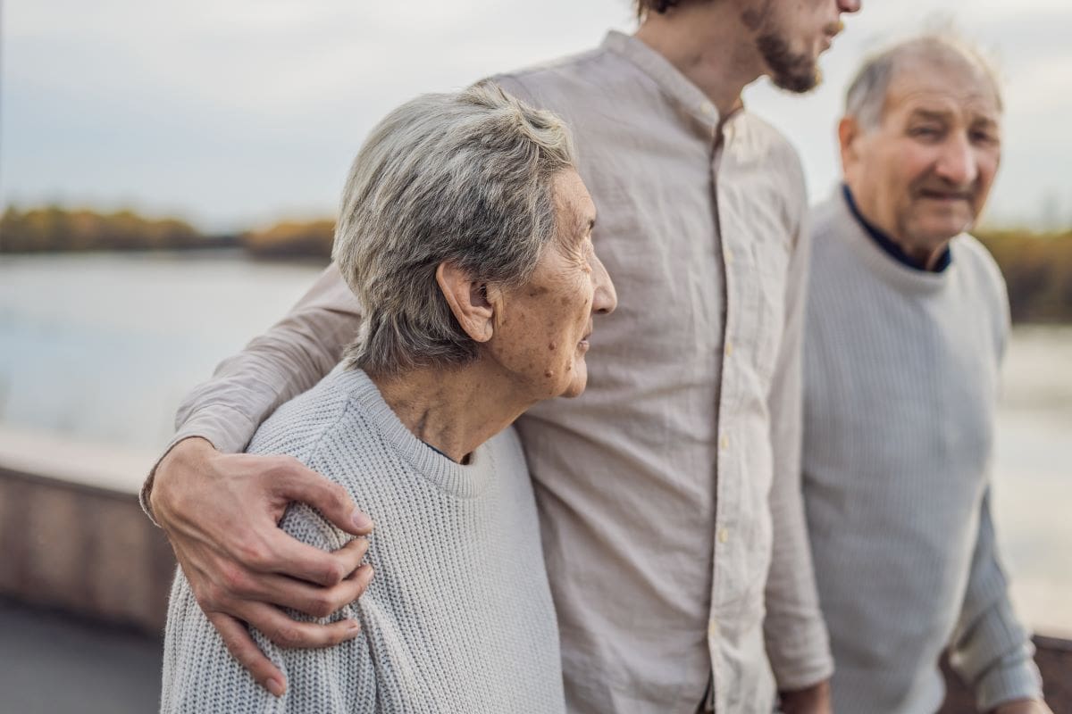 younger man in the middle of two older people