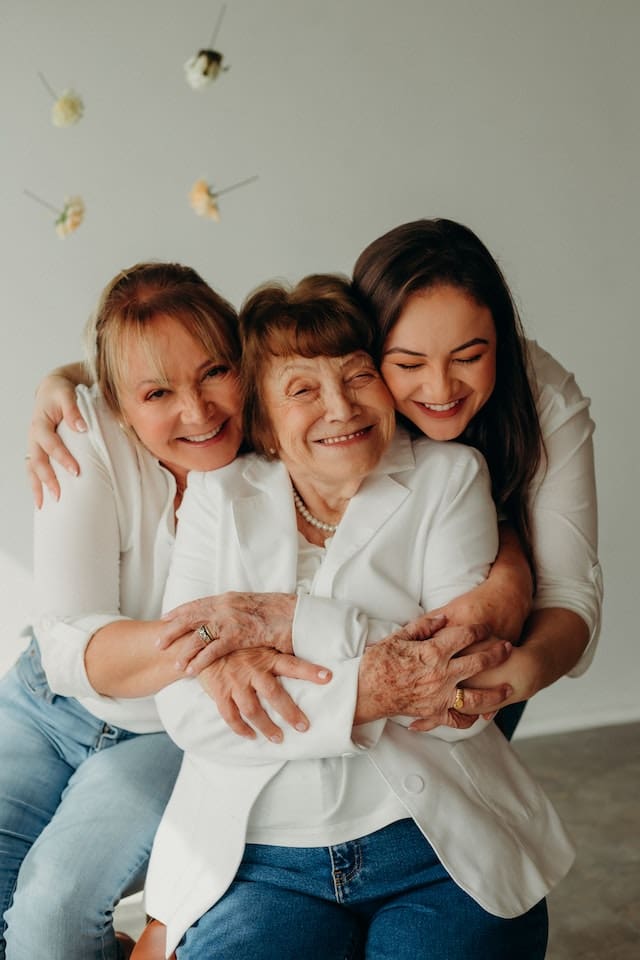 mom sandwich Daugther embracing mother