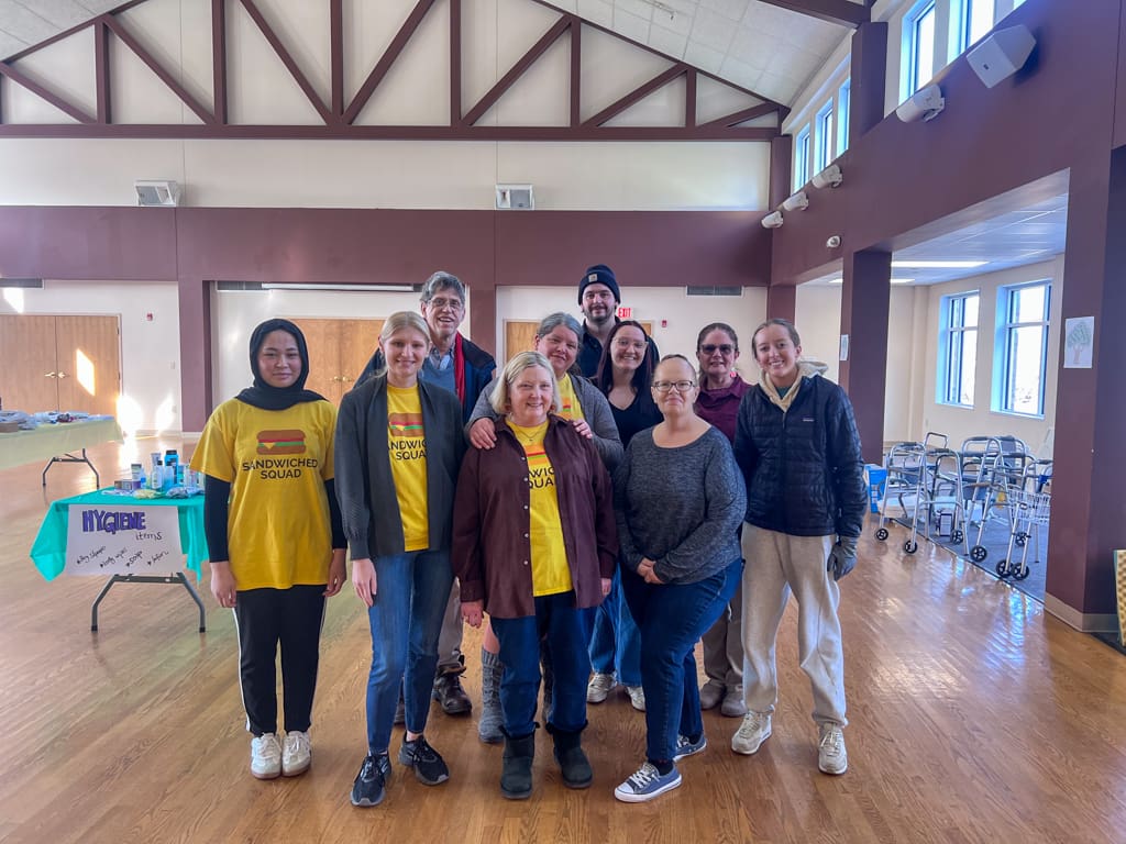 A group of three volunteers posing for a photo at the swap